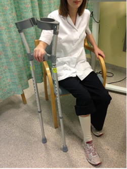 sitting with crutches.png