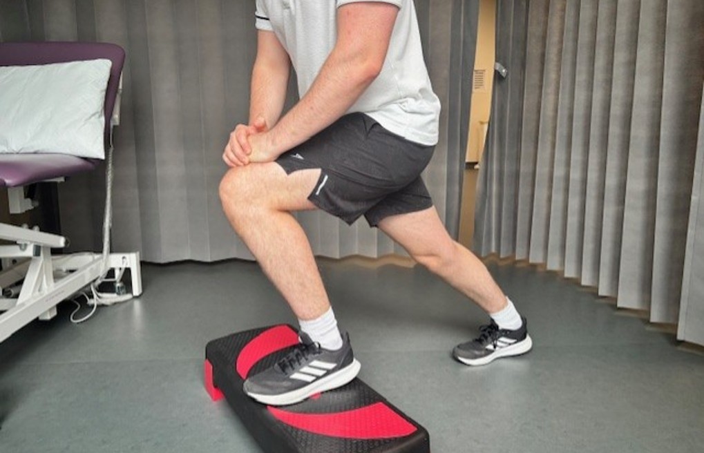 knee bend stretch on step.jpg