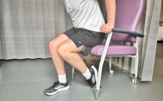 reverse assisted knee bend in chair.png
