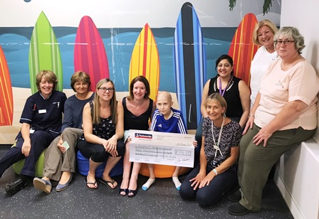 Patient Luke Wilson and mum Julie, third from left, presents a cheque for £3,794.11 to Dr Johanna Aspel, centre, and paediatric staff at Wexham Park Hospital.