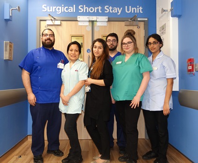 A small group of staff standing outside the door to the surgical short stay unit