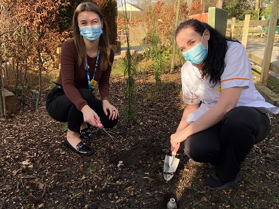 Apprentices Mia Meades (left), a Learning and OD Adviser, and Kerrie Bowyer, a Nursing Associate trainee, plant seed bombs at Frimley Park