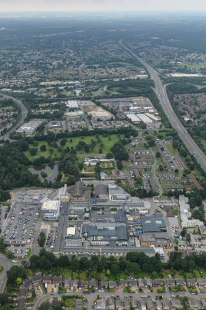 An aerial photo of frimley park hospital taken from the east, showing the landscape and horizon to the west.