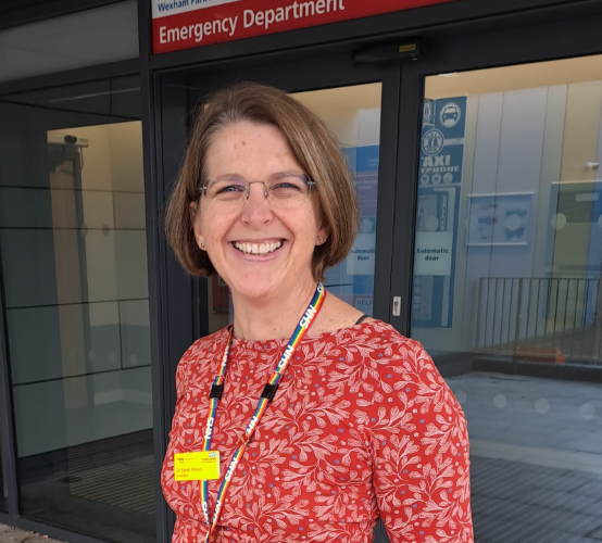 Dr Sarah Wilson standing in front of the Emergency Department entrance.